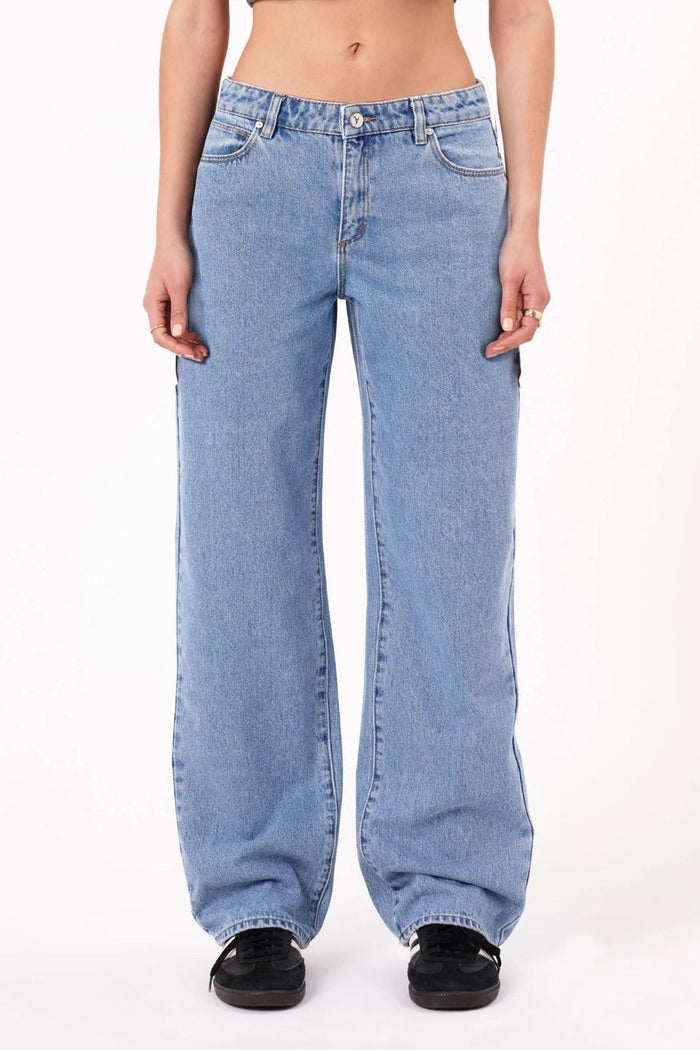 Light blue jeans worn by a person on a white background