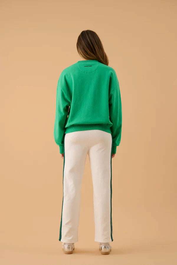 green and white sweater with text on front