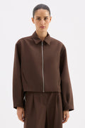 Person wearing a brown outfit on a white background