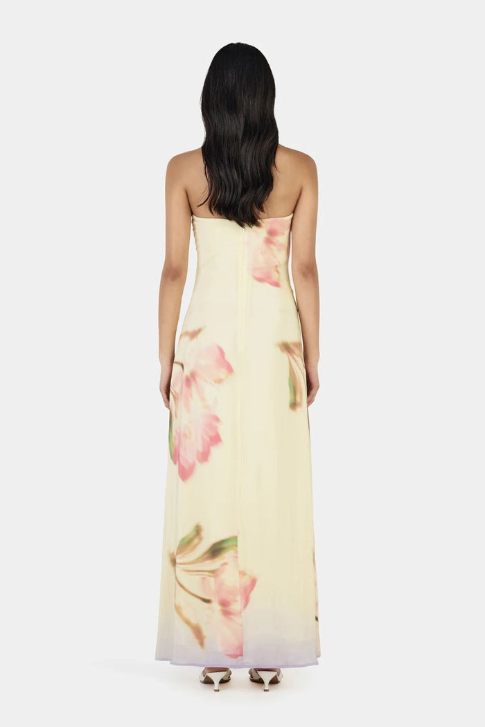 Woman wearing a floral strapless dress on a white background
