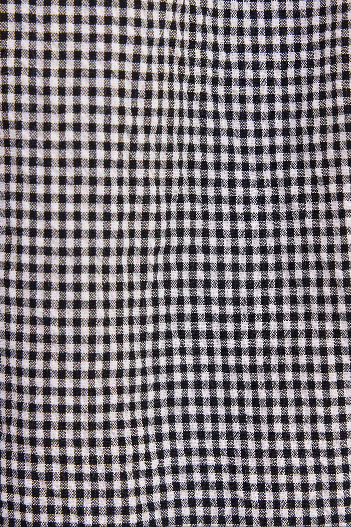 A close-up of a black and white gingham checkered fabric texture.
