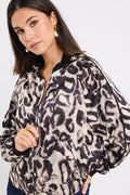 model wears a leopard bomber jacket with dark blue jeans
