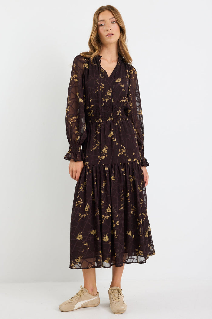 Woman wearing a black floral dress on a white background