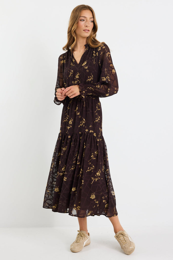 Woman wearing a black floral dress on a white background