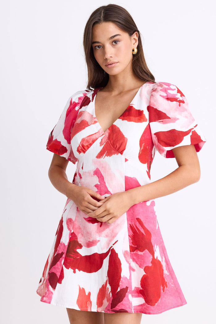 Woman wearing a pink and red floral dress on a white background
col_pattern