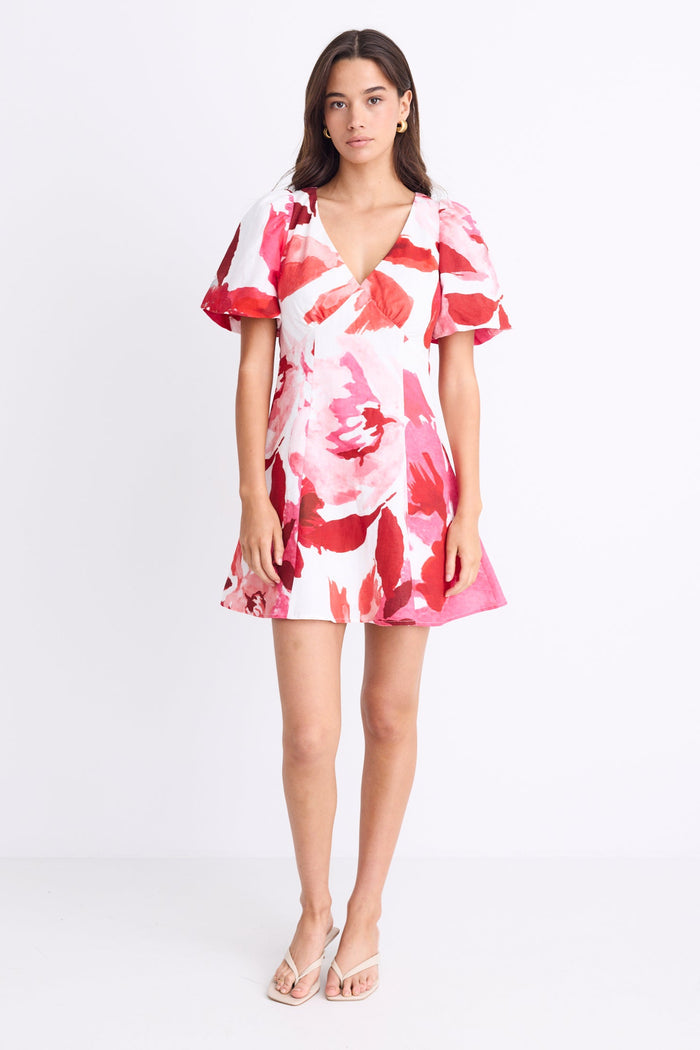 model wearing red white pink floral mini dress