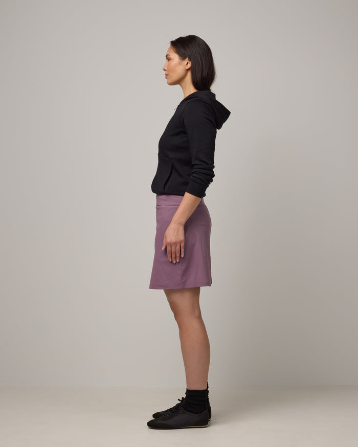 Model wearing Adventure Skort in Lavender. Adventure Skort is a merino wool above-knee length skort with pockets available in sizes XS-XXL.