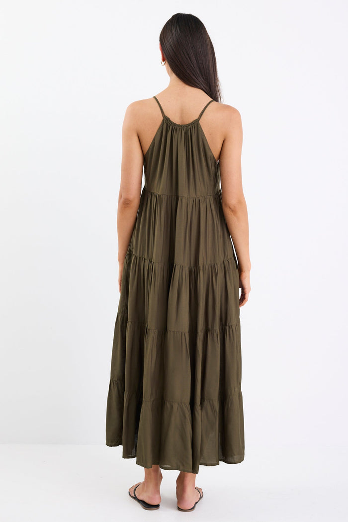 Woman wearing an olive green dress on a white background