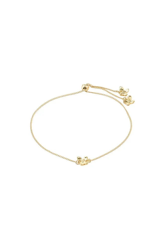 Gold bracelet with a small decorative element on a white background