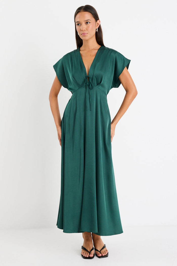 Woman wearing a green dress on a white background