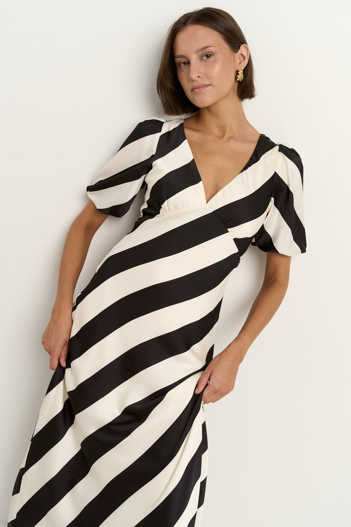 model wears black and white stripe dress