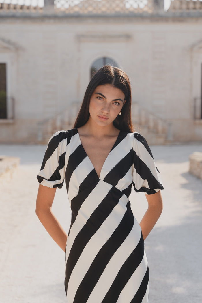 model wears black and white stripe dress
