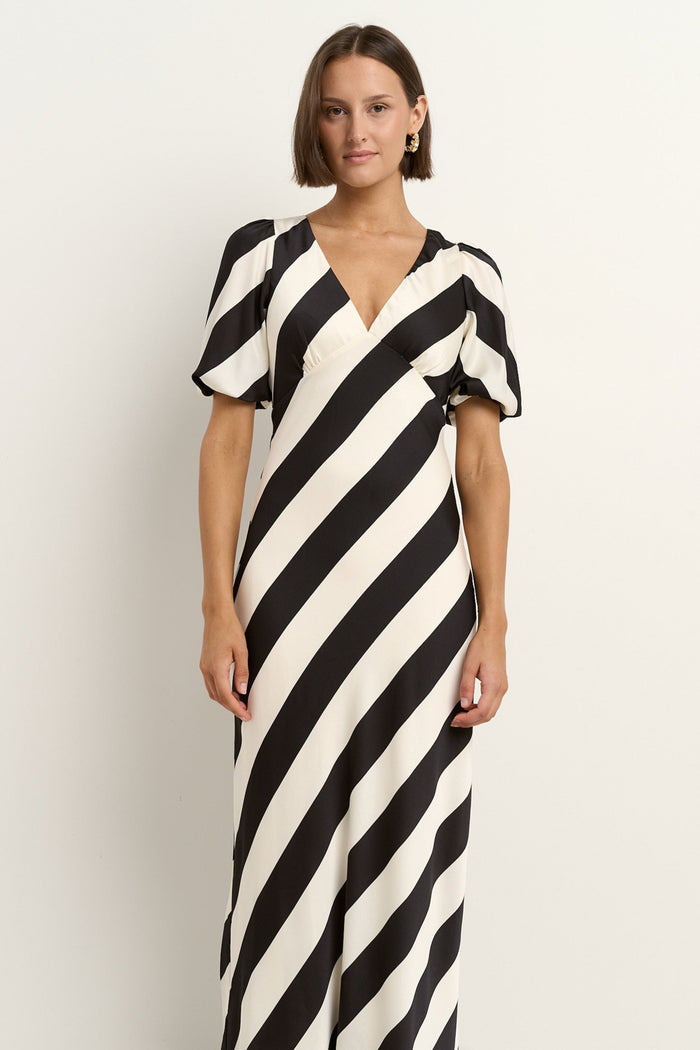 model wears black and white stripe dress