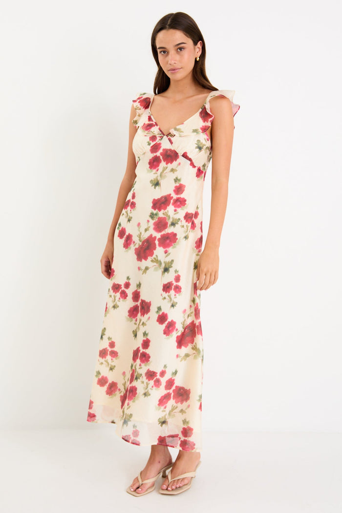 Woman wearing a floral white dress with frills