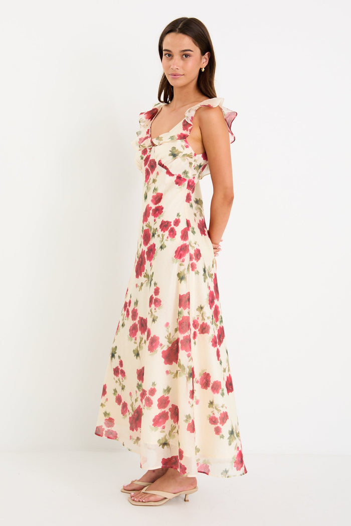 Woman wearing a floral white dress with frills