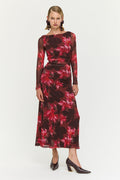Model wearing a floral dress with long sleeves on a white background