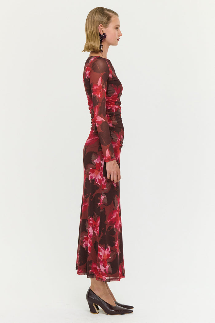 Woman wearing a red floral dress on a white background