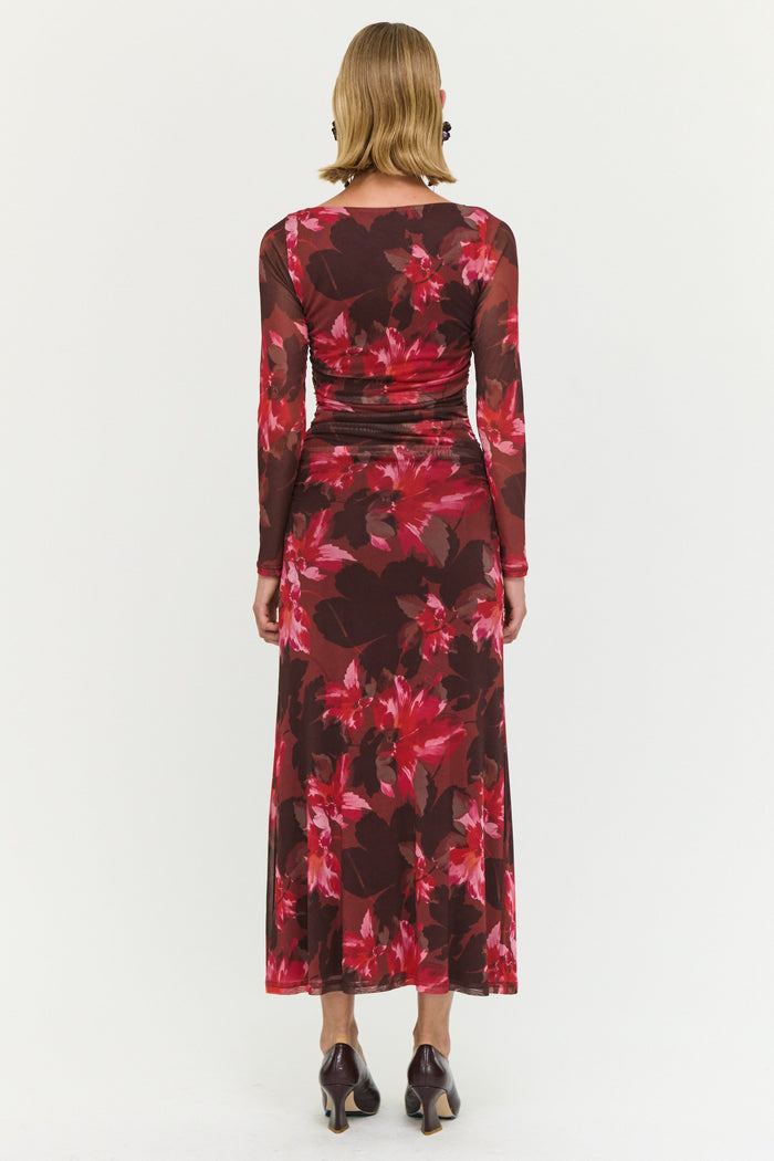 Woman wearing a red floral dress on a white background