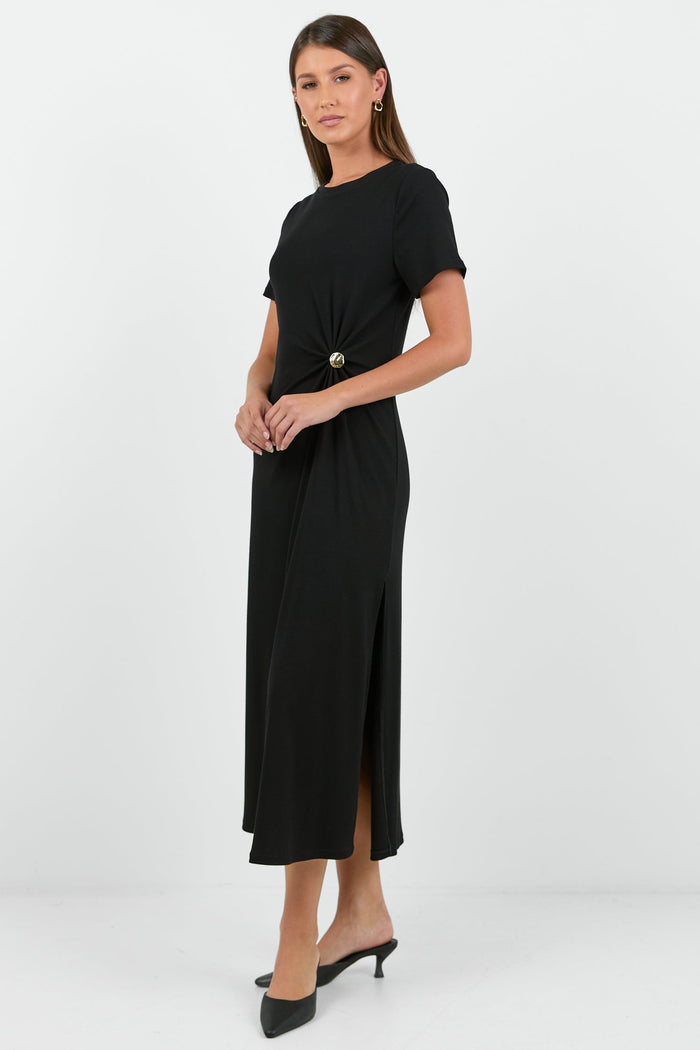 Woman wearing a black dress with a knot detail on a white background