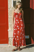 Woman wears a red floral strappy maxi dress