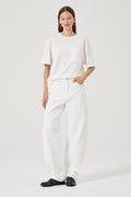 Woman wearing white wide leg jeans