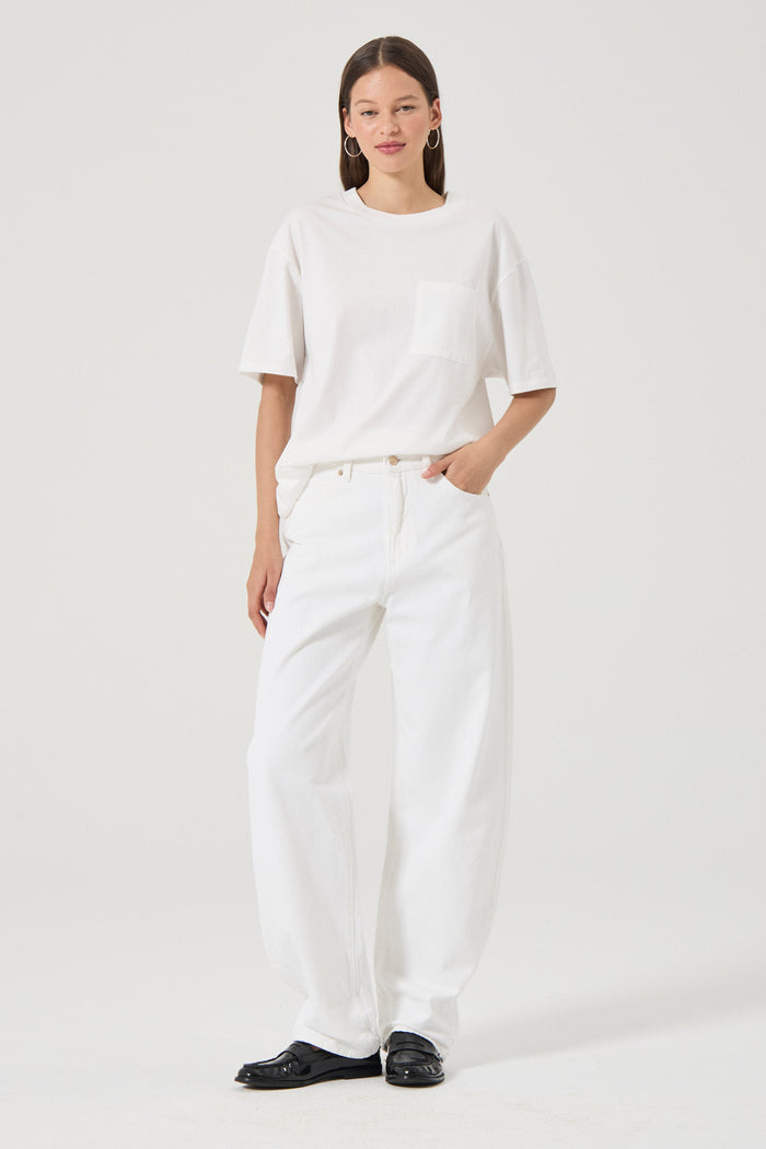 Woman wearing white wide leg jeans