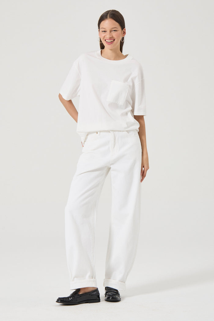 Woman wearing white wide leg jeans