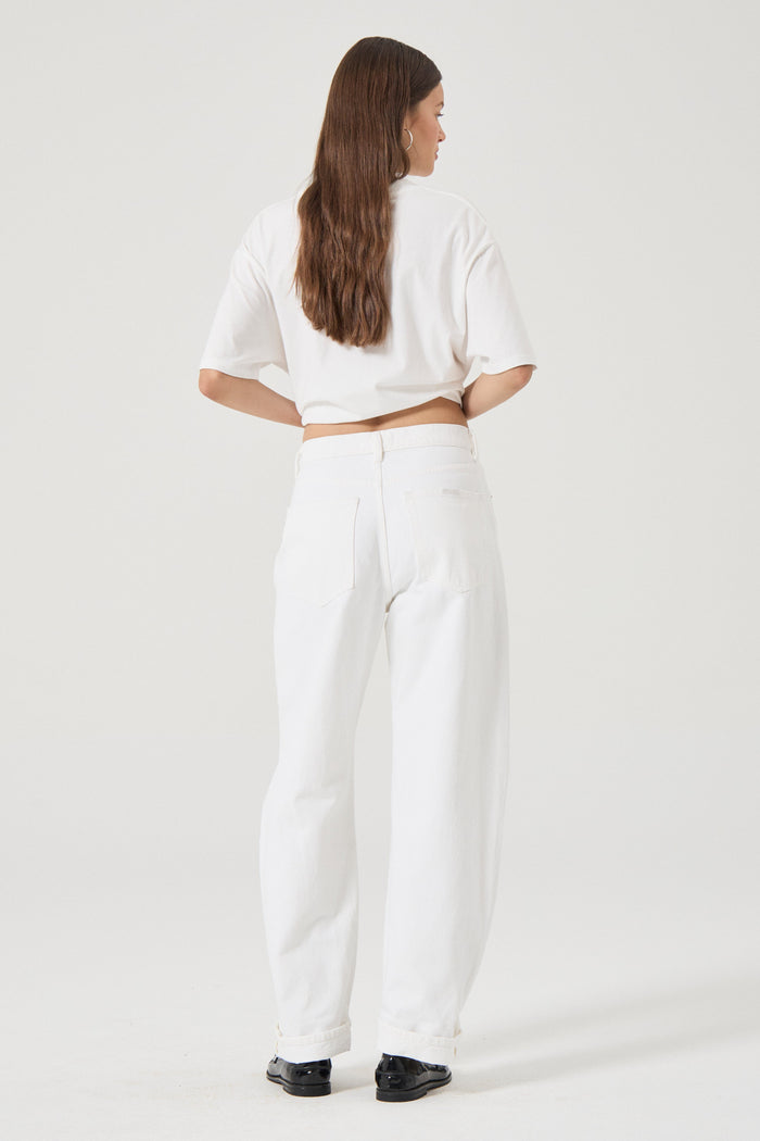 Woman wearing white wide leg jeans