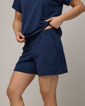 Model wearing Aspen Short in Marine Blue, a deep royal blue color. Aspen Short is a merino wool sweat short with 5in inseam available in sizes XS-XXL.