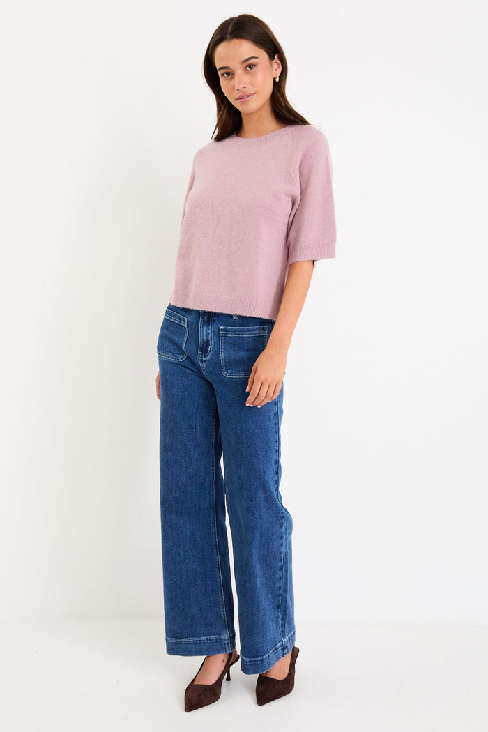 Model wearing a blush short sleeve raglan knit tee with a soft crew neckline and relaxed fit.
