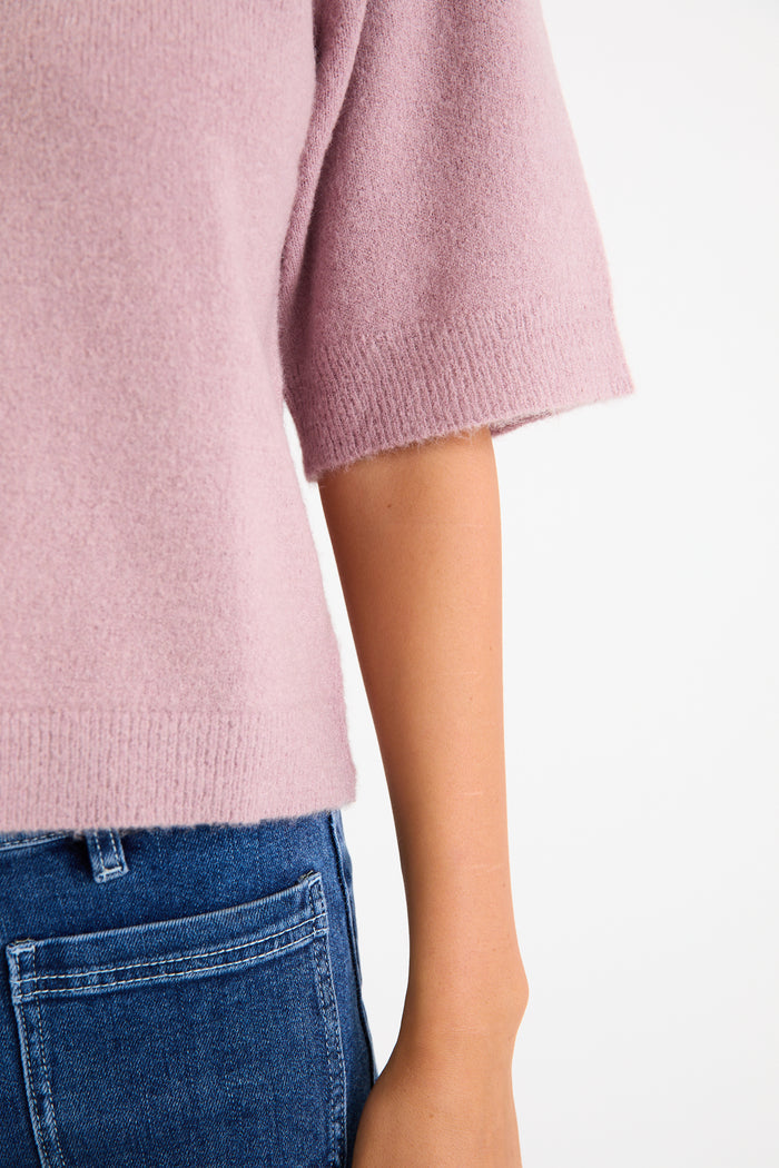 Model wearing a blush short sleeve raglan knit tee with a soft crew neckline and relaxed fit.