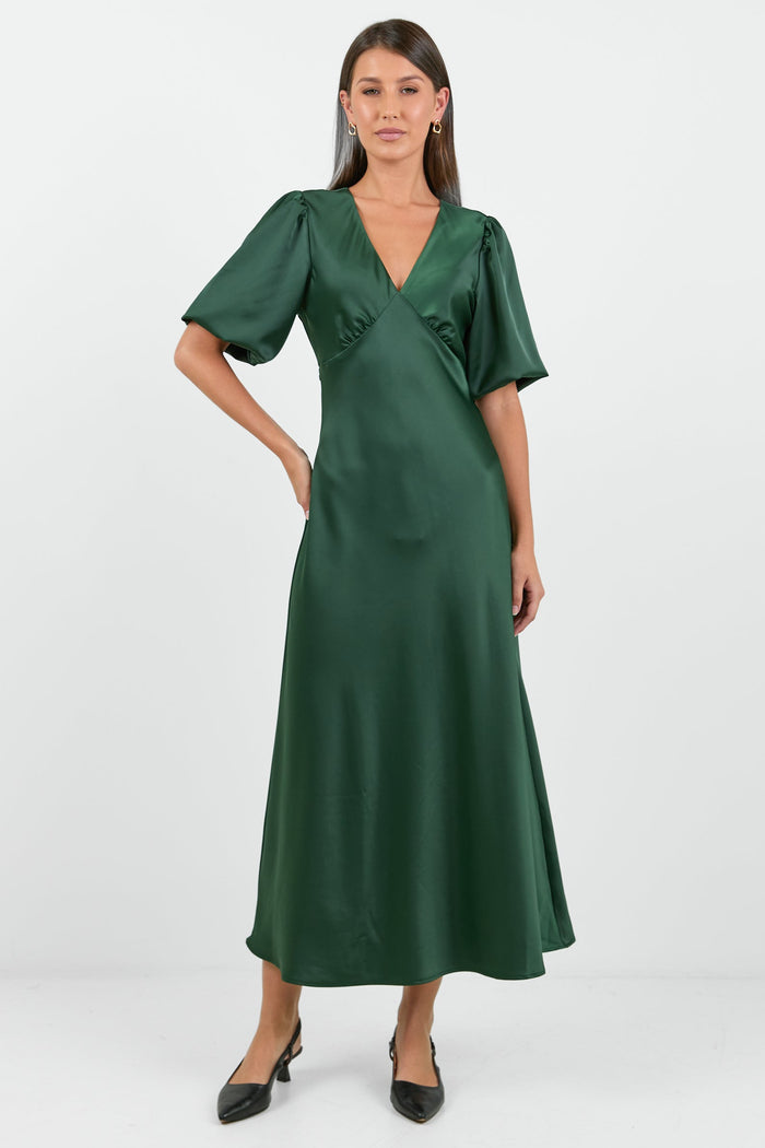 Woman wearing a green dress on a white background