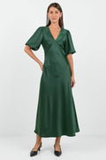 Woman wearing a green dress on a white background