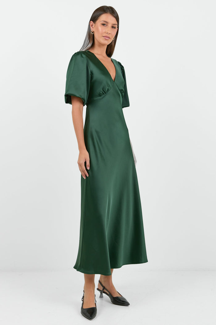 Woman wearing a green dress on a white background