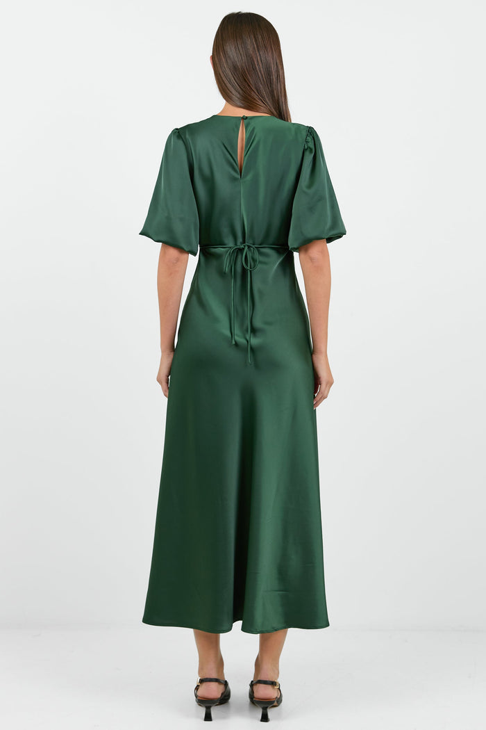 Woman wearing a green dress on a white background