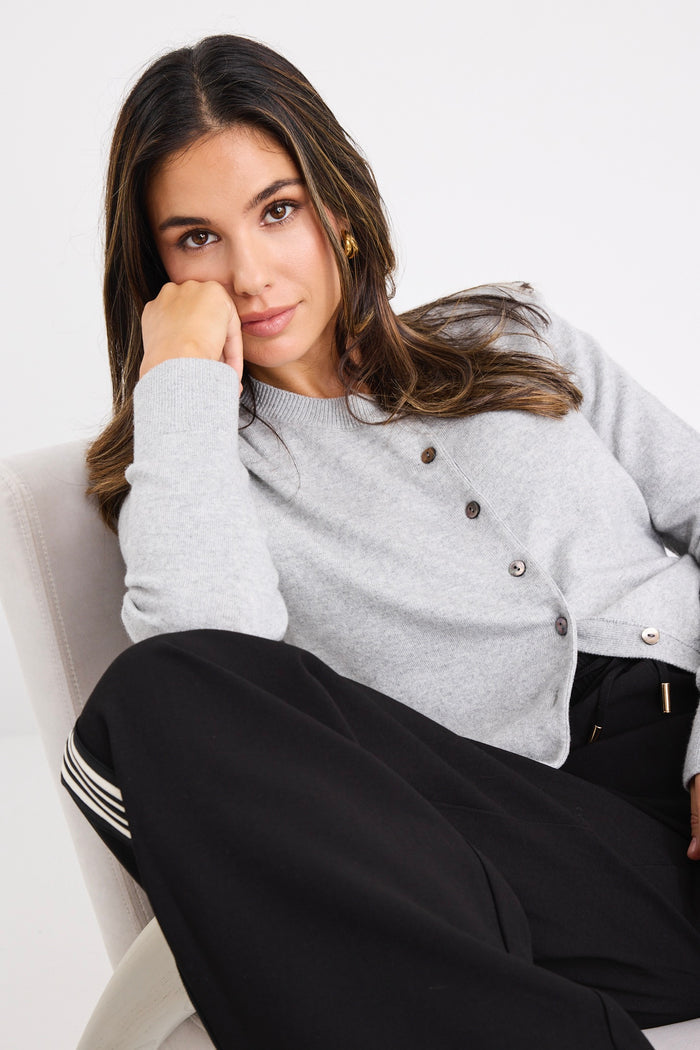 model wears a grey long sleeve cardigan
