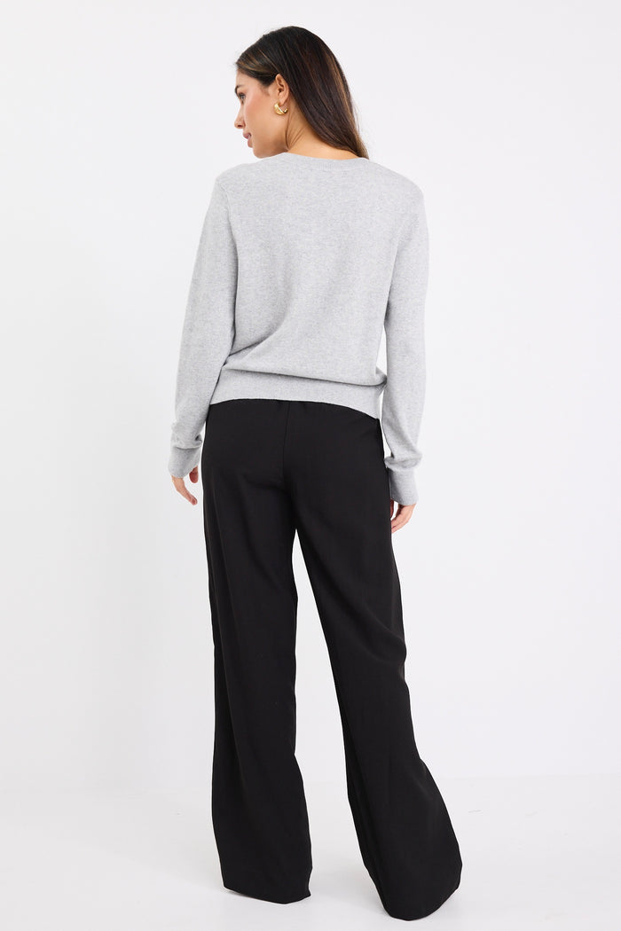 model wears a grey long sleeve cardigan