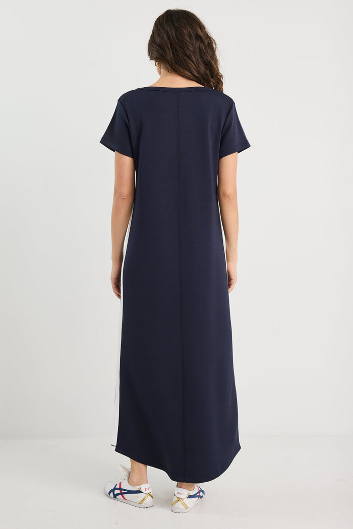 Person wearing a long navy dress on a white background