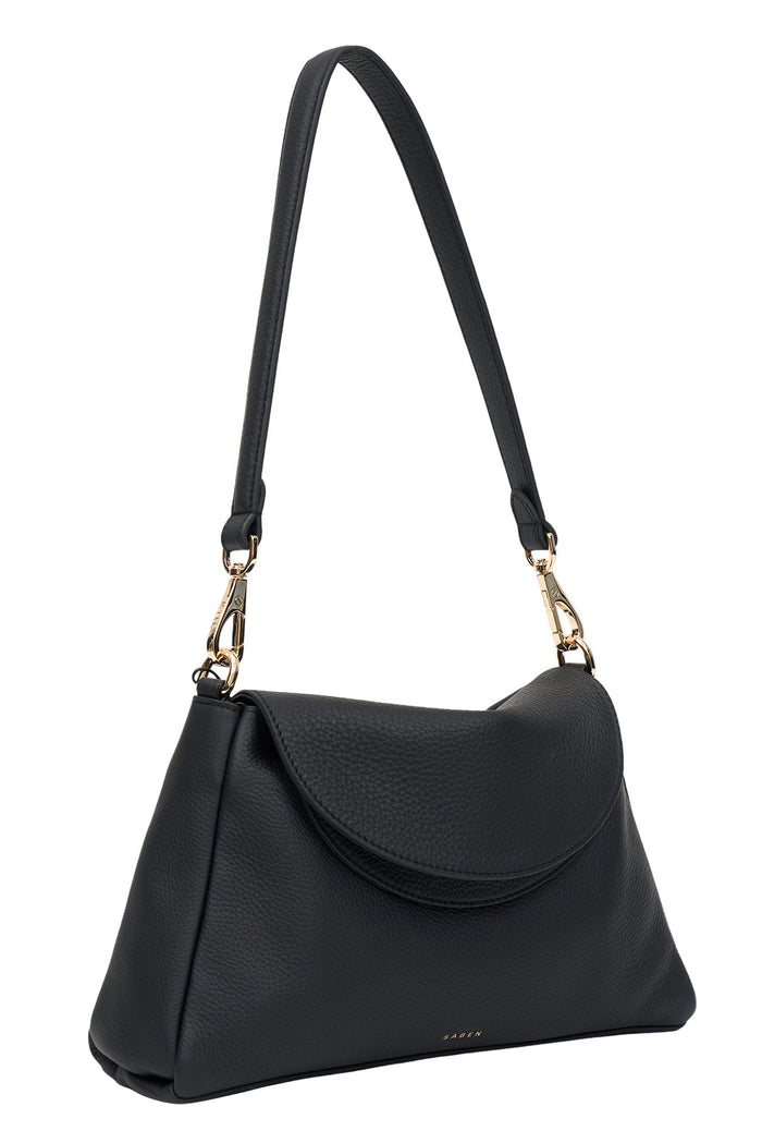 Black handbag with a gold clasp on a white background