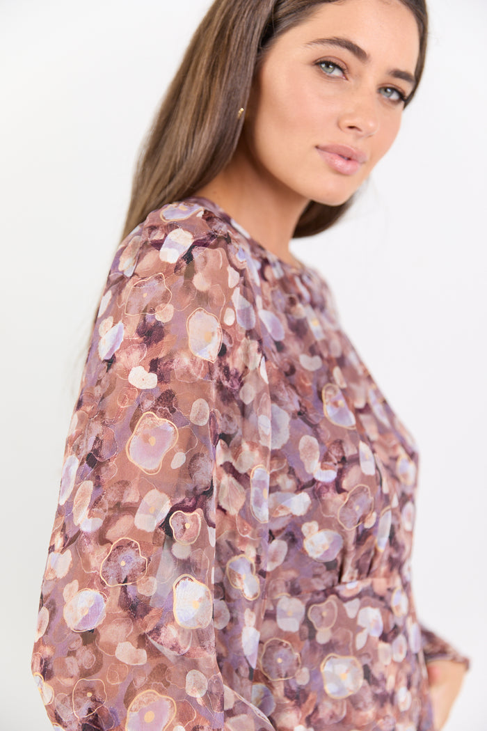 Woman wearing a floral blouse with a white background