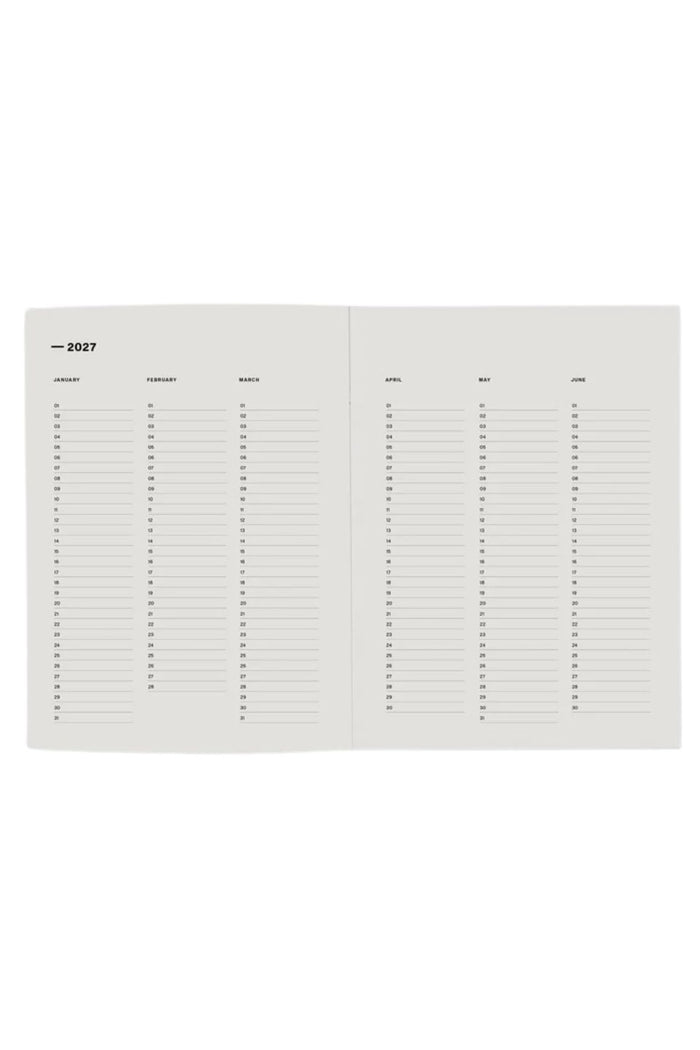 An open planner or calendar showing blank monthly writing pages with columns for day, weekday, event, place, and notes, photographed on a plain white background.