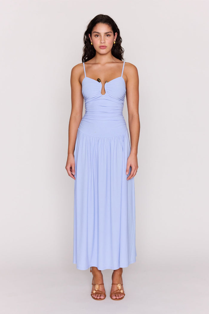 Woman wearing a light blue dress on a white background
