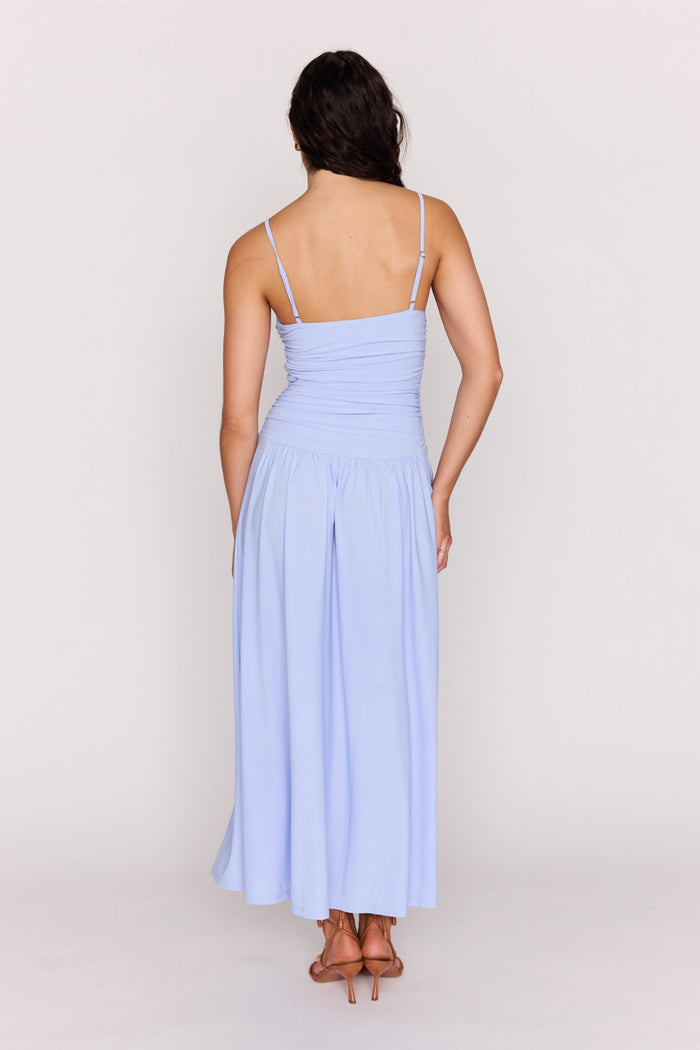 Woman wearing a light blue dress against a white background