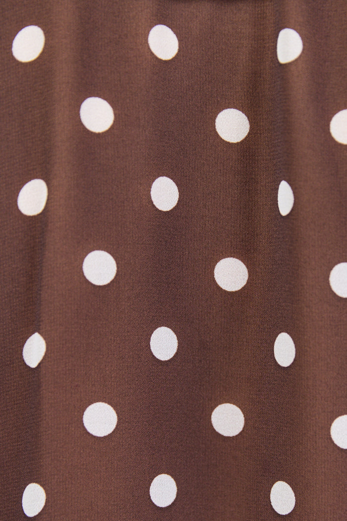 Brown fabric close-up with white polka dots