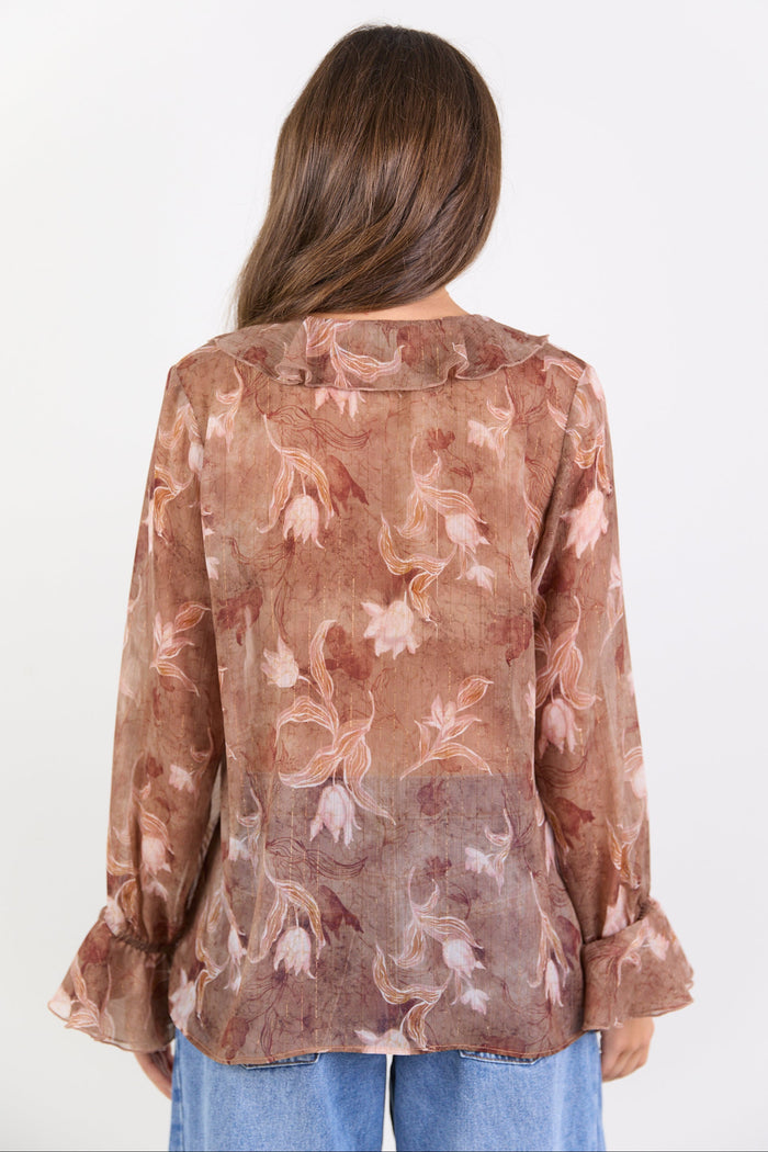 Woman wearing a floral blouse with a white background
