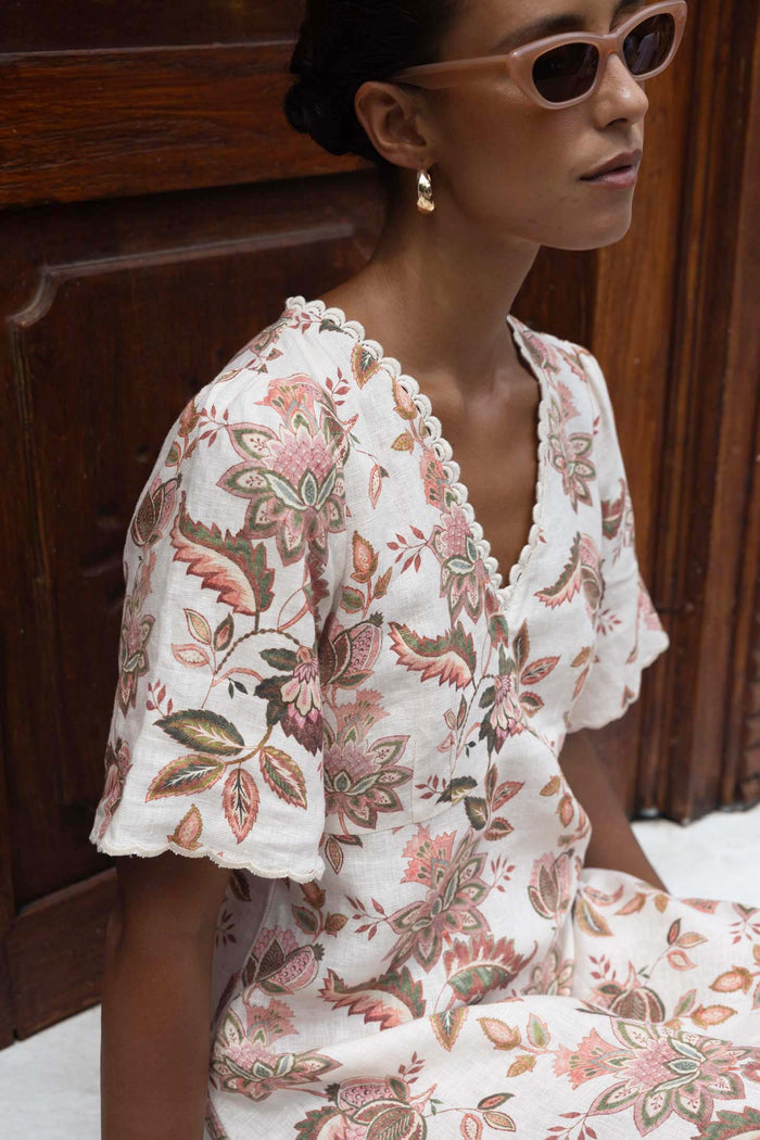 Woman wearing a floral dress with a wooden background