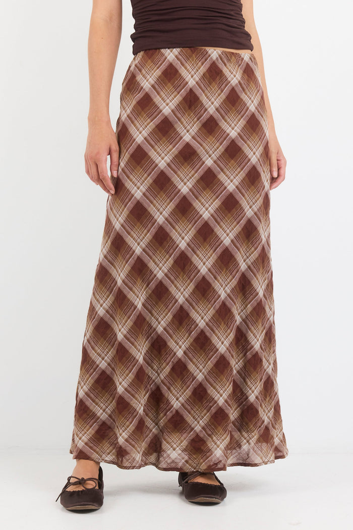 Person wearing a plaid skirt on a white background