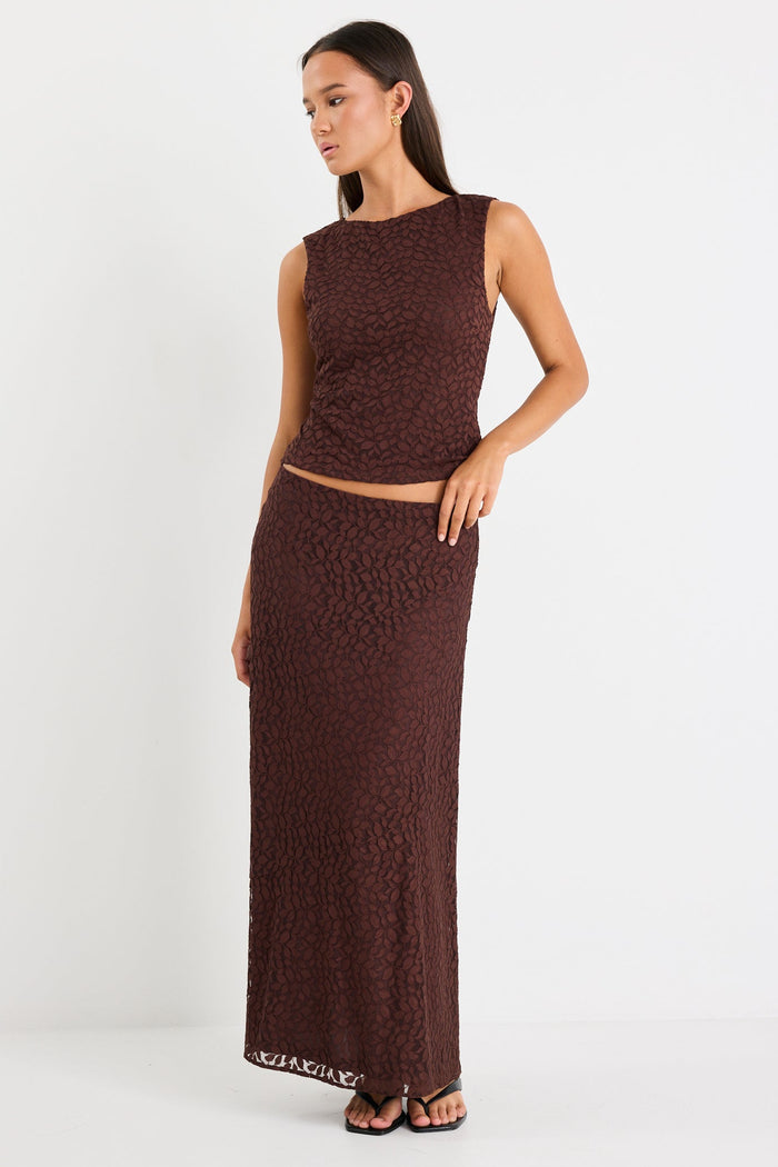 Woman wears a brown lace top