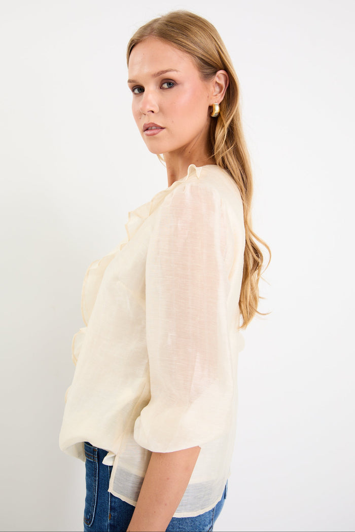 cream frill top and blue jeans