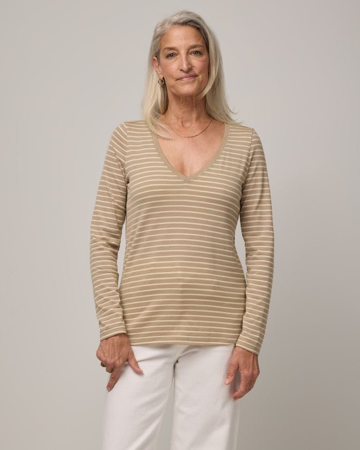 Model wearing Brenton V-Neck Tee in Khaki & Natural White Stripe. Brenton V-Neck Tee is a merino wool long sleeve, v-neck, regular fit tee available in sizes XS-3X.